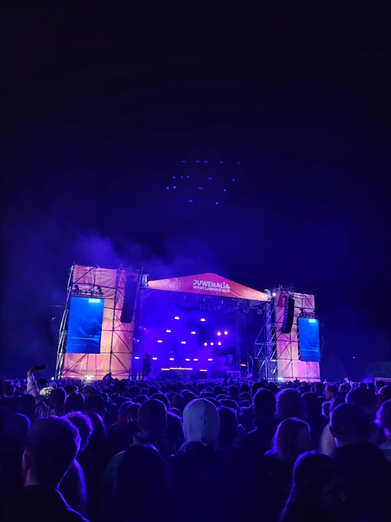 A festival stage lit in blue and pink at night during Juwenalia in Wrocław